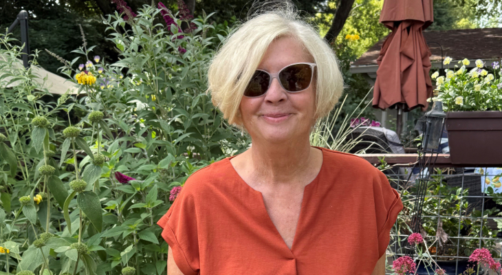 Barbara Tiney wearing sunglasses and standing in a garden. 