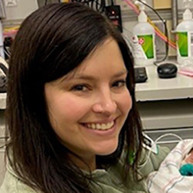 Smiling brown-haired woman, headshot.