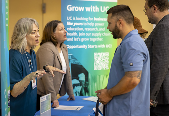 A business owner meets with a department rep at the Supplier Expo.