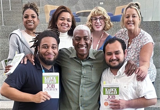 Fred Stevenson, center, surrounded by six trainees that he mentored with job search skills.