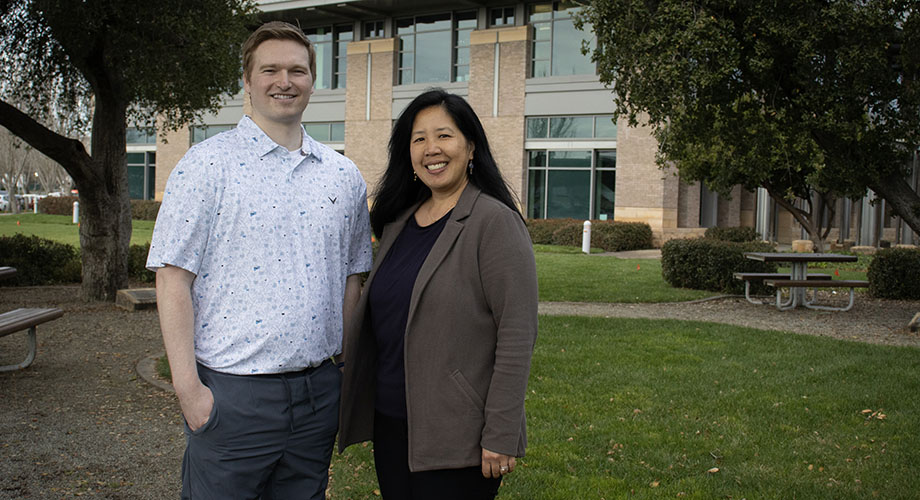 A man and woman post for a portrait outside the UC Davis MIND Institute 