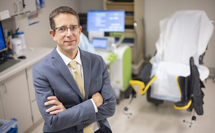 A physician stands in a patient room