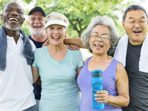 A group of senior adults stand together after exercising