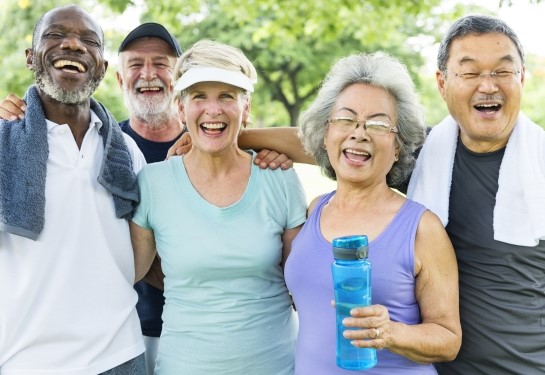 A group of senior adults stand together after exercising