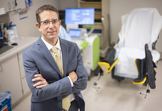 image of male doctor standing in exam room portrait