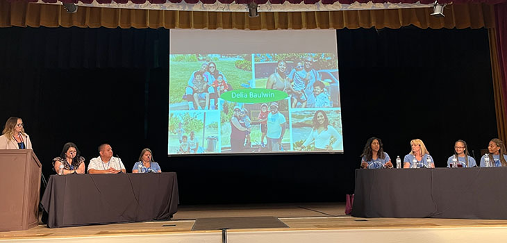 panel sitting behind a long table at a conference