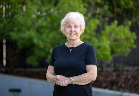 Else Carr wearing a black shirt and standing at an angle.